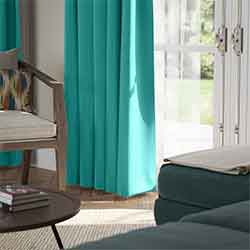 A beautiful set of white taped wooden blinds in a very bright room